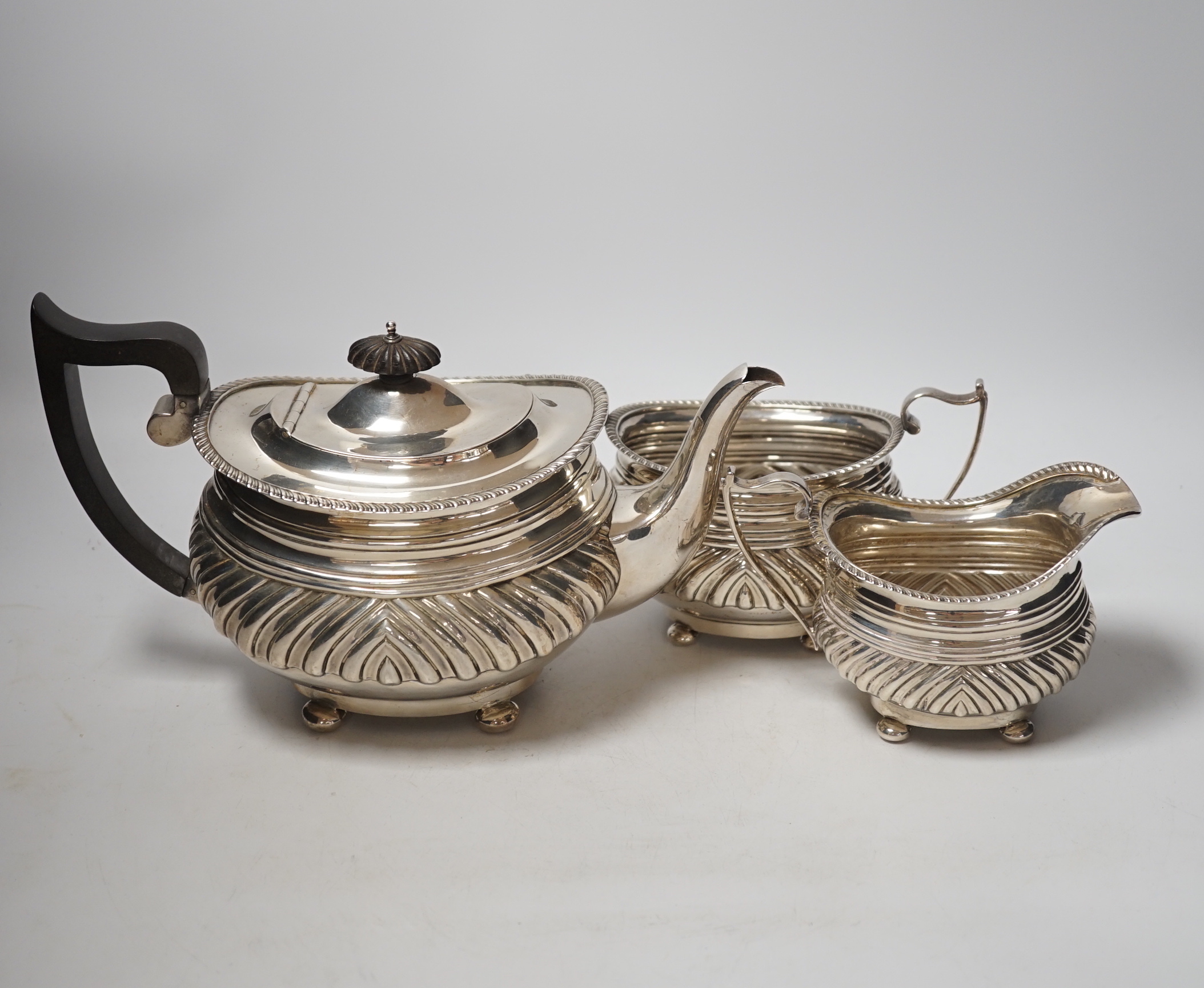 A George V demi fluted silver three piece tea set, Nathan & Hayes, Chester, 1913, gross weight 37.2oz.